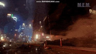 a video of a city at night with a sign that says m.e.m. on the bottom
