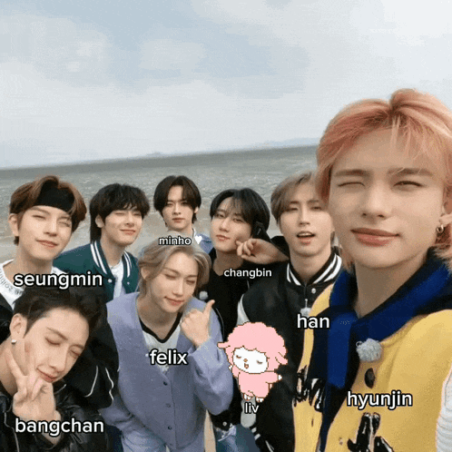 a group of young men are posing for a picture with the names felix and hyunjin on the bottom