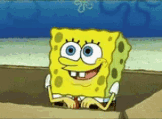 spongebob squarepants is smiling while sitting on a rock in front of the ocean .