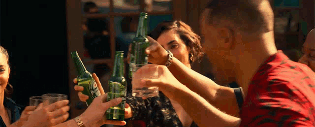 a group of people are toasting with bottles of diet pepsi