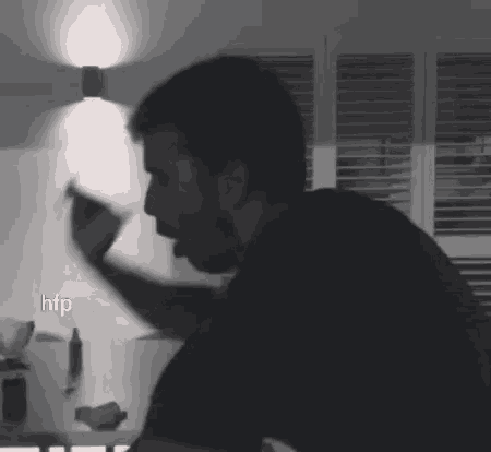 a black and white photo of a man with the letters htp visible