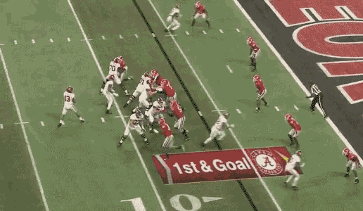 a football game is being played in front of a large sign that says georgia