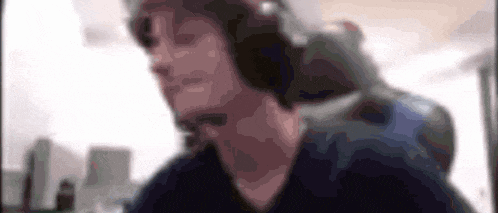 a blurry picture of a man wearing headphones and a headset