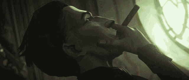 a man is smoking a cigar with his eyes closed