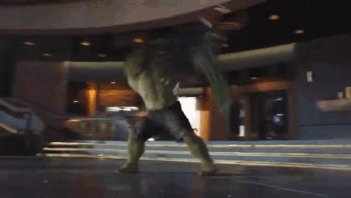 a hulk is standing in front of a building with stairs