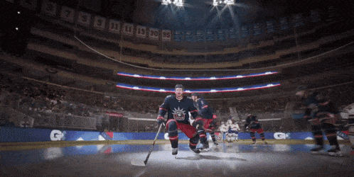 a hockey game is being played in a stadium with gatorade advertisements
