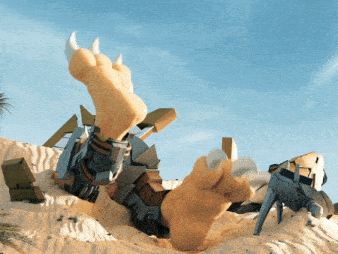 a statue of a monster laying in the sand