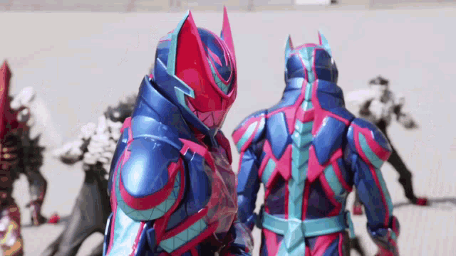 a man in a blue and red armor is standing next to another man in a red and blue armor
