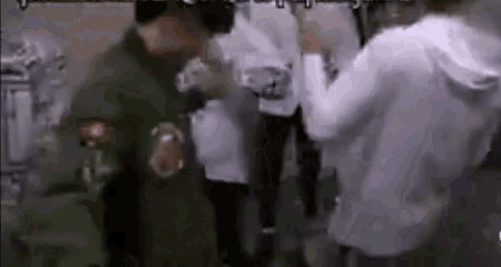 a group of people are standing in a room .