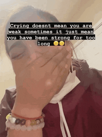 a woman wearing a mask covering her mouth with her hand and a quote about crying