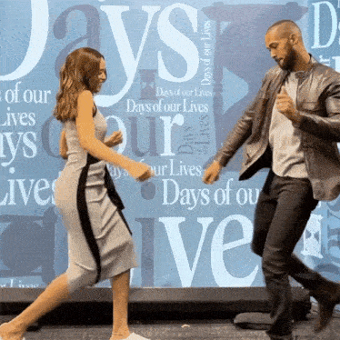 two people are dancing in front of a wall that says days of our lives