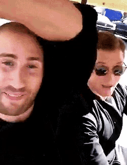 two men wearing sunglasses are posing for a picture together
