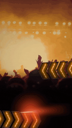 a crowd of people at a concert with arrows pointing to the left