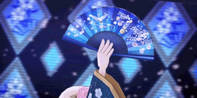 a woman in a kimono is holding a blue fan in her hand