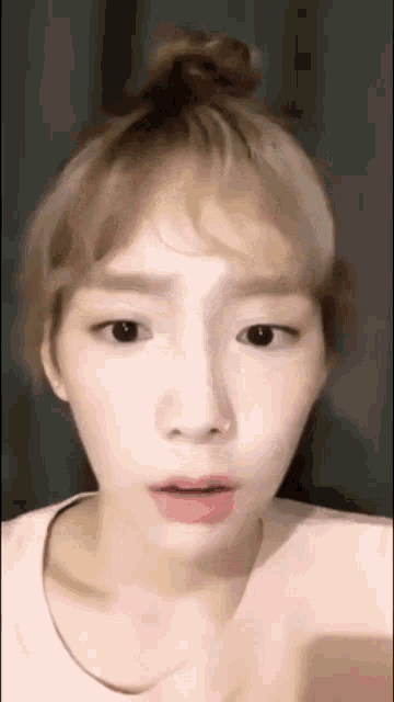 a close up of a woman 's face with her mouth open