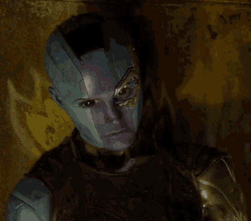 a close up of a person 's face with purple and blue paint on it .