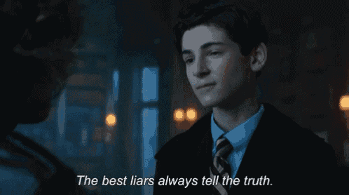 a man in a suit and tie is talking to another man with the words " the best liars always tell the truth " above him