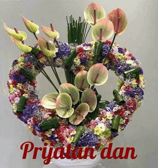a bouquet of flowers in a heart shaped vase with the words prijan dan below it