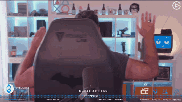 a man sitting in a secret lab chair waving his hands