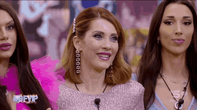 a group of women standing next to each other with the words #gfvip on the bottom left
