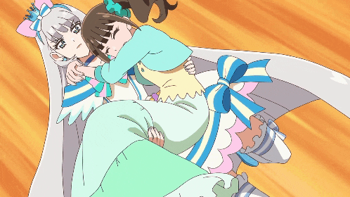 a girl in a white dress is holding another girl in a blue and white dress