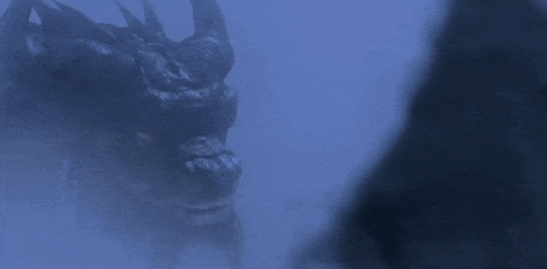 a close up of a monster with its mouth open in the dark