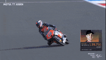 a man is riding a motorcycle on a track with the words motul tt assen on the top
