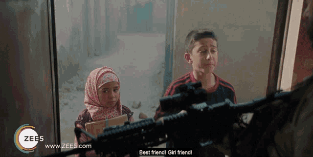 a boy and a girl are standing in front of a rifle with the words best friend girl friend on the bottom right