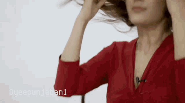 a woman in a red shirt is holding her hair in front of a white background that says oyeepunjaban1