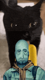 a man with a blue face is standing in front of a cat