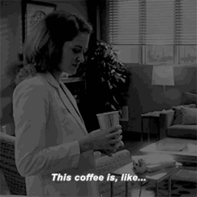 a black and white photo of a woman holding a cup of coffee and saying " this coffee is like "