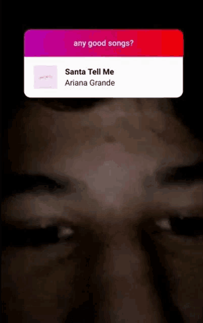 a close up of a person 's face with a question about santa tell me ariana grande .