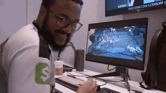 a man sitting in front of a computer with a sign that says save using code