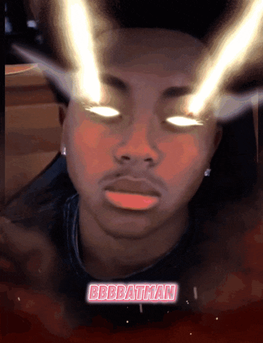 a man with glowing eyes and the name bbbbatman on the bottom right