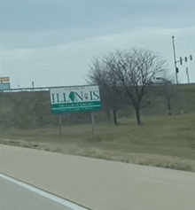 a sign for illinois is on the side of a highway