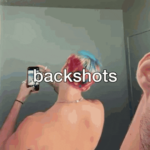 a man taking a picture of his back with the words backshots