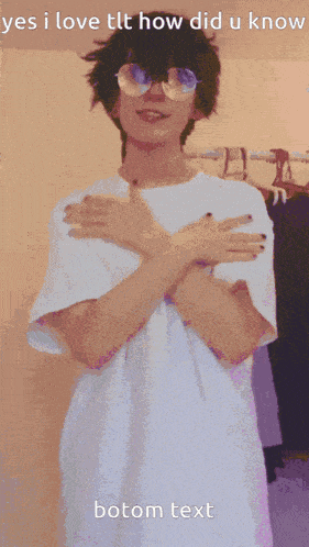 a person in a black and white dress holds their hands on their stomach in front of a purple background
