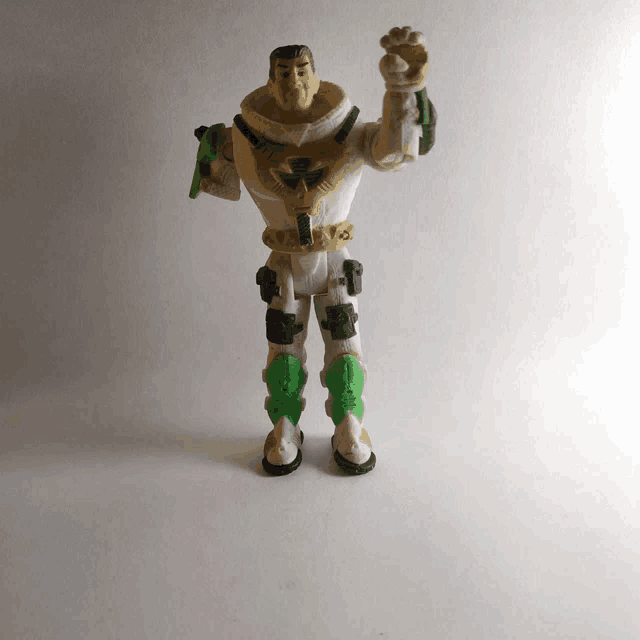 a toy soldier with green knee pads holds a gun
