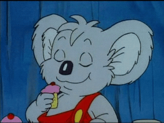 a cartoon koala bear is eating a cupcake with a strawberry on top