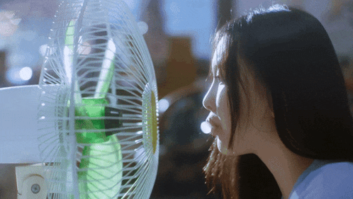 a woman stands in front of a fan that has the number 2222 on it