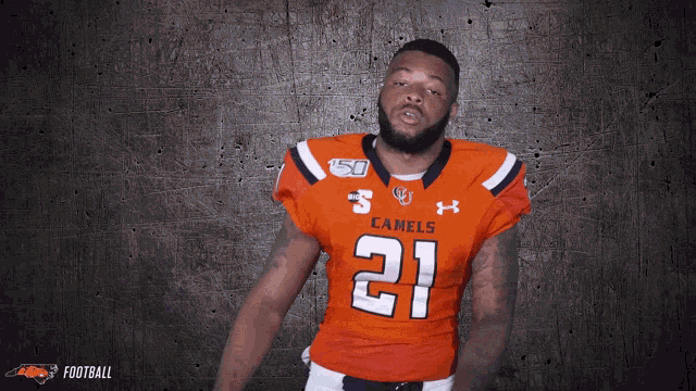 a man wearing an orange jersey with the number 21