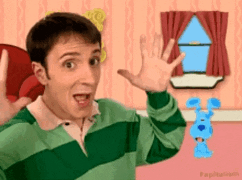 a man in a green and white striped shirt is standing in front of a window with a blue dog in the background .