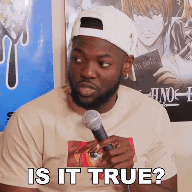 a man holding a microphone in front of a death note poster says is it true