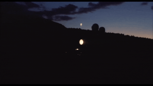 the moon is visible in the night sky