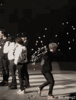 a group of people on a stage with bh hong2 in the corner