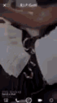 a close up of a person wearing a suit and tie on a cell phone .