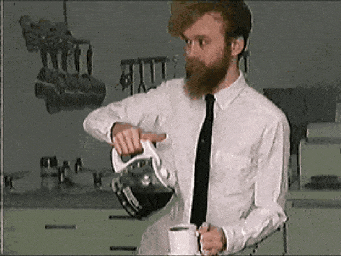 a man in a white shirt and tie is pouring coffee into a mug