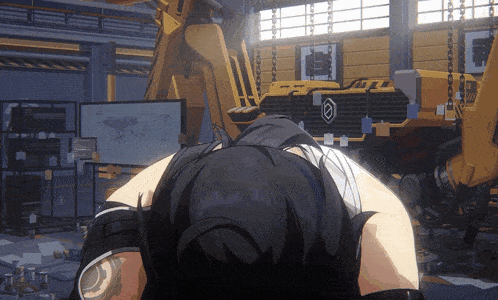 a girl is laying on the floor in front of a large yellow vehicle with the letter a on the side