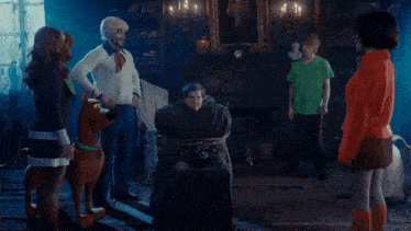 a man in a scooby doo costume is holding up his arm