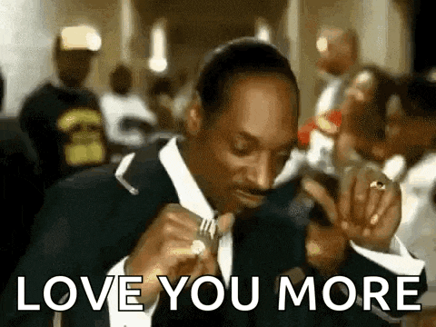 snoop dogg is wearing a tuxedo and holding a fork in his mouth .